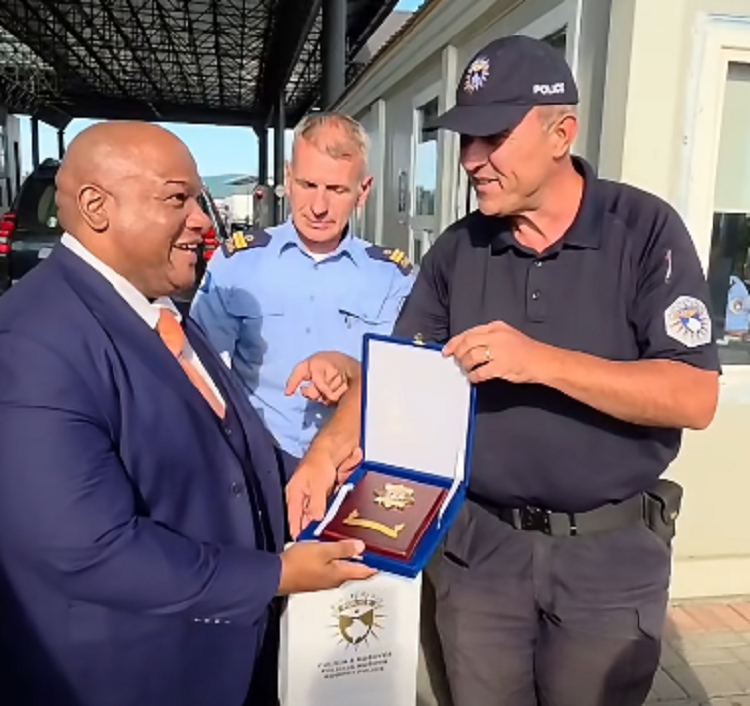 Kosovo police officers send their regards to Trump and present gifts to an American pastor